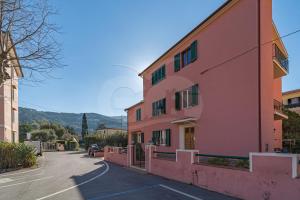 a pink building on the side of a street at La Piazzetta di Marciana Marina - Goelba in Marciana Marina