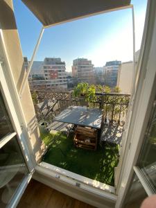 a balcony with a table and a view of the city at Montparnasse Paris 15 in Paris