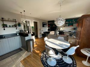 a dining room and living room with a table and chairs at Montparnasse Paris 15 in Paris