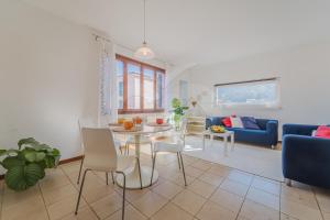 a living room with a table and a blue couch at La Piazzetta di Marciana Marina - Goelba in Marciana Marina +18 photos