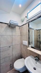 a bathroom with a toilet and a sink at Hotel Sorriso in Cattolica