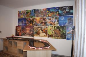 a desk in a room with a wall covered in pictures at Spacious house in the outskirts of Budapest in Budapest