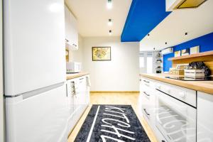 a kitchen with white appliances and a blue ceiling at 180 Panoramic Views Fully Equipped For 6 Acs in Sofia