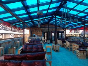 a room with couches and tables and blue ceilings at OCEAN6 in Accra