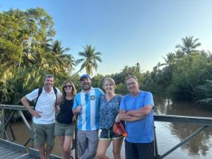a group of people posing for a picture on a bridge at Bentre Coco Lodge in Ben Tre