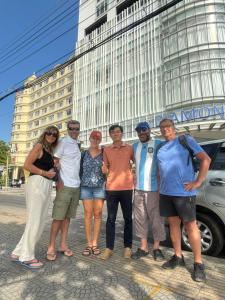 a group of people standing in front of a building at Bentre Coco Lodge in Ben Tre