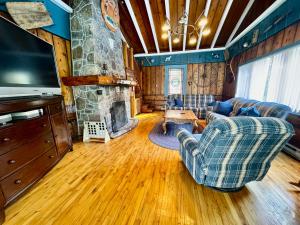 a living room with a couch and a fireplace at Fireplace beach access pet friendly in Sainte-Agathe-des-Monts