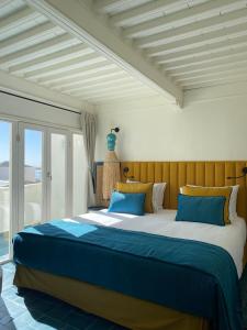 a bedroom with a large bed with blue pillows at Le Palazzo in Essaouira