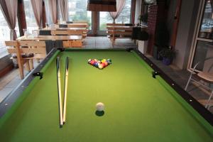 a pool table with cue balls and cue sticks at Akwen in Rewal