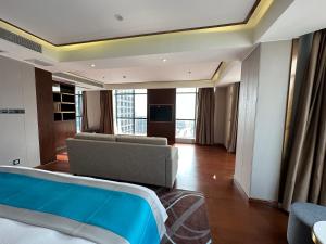 a hotel room with a bed and a couch at XI AN JIU DIAN Hotel in Sihanoukville