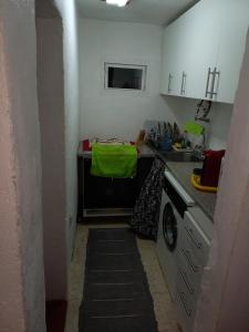 a small kitchen with a sink and a dishwasher at Casa Serrana in Penhas da Saúde