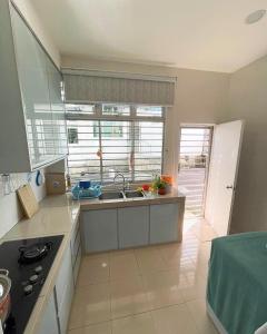 a large kitchen with a sink and a window at Entire 4 BDR white house @ Yong Peng in Yong Peng