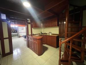 a kitchen with wooden cabinets and a staircase in it at Plaza Historic Lima in Lima