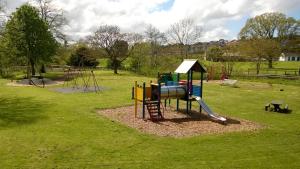 a playground with a slide in a park at Two Bedroom Apartment in South Somerset in Wincanton