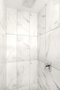 a white marble shower with a glass door at 153-5A Charming 2BR LES W D in New York
