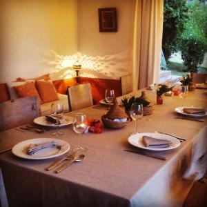 a table with plates and wine glasses on it at Dar Al Manar in El Jadida