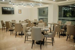 a restaurant with tables and chairs in a room at Regenta Place Vasco Goa in Marmagao