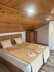 a large bed in a room with a wooden ceiling at Plovdiv center apartments 7 in Plovdiv