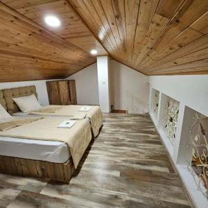 a bedroom with a large bed with a wooden ceiling at Plovdiv center apartments 7 in Plovdiv