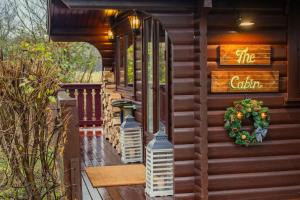 a front porch of a house with a christmas wreath at The Cabin in Marlow