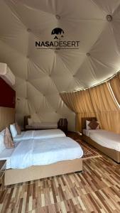a bedroom with two beds in a tent at Nasa desert luxury camp in Wadi Rum