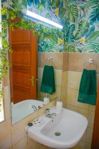 a bathroom with a sink and a mirror at House of DC- stylish 2 bedroom apartment in Kahawa