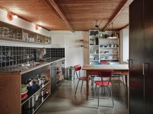 a kitchen with a wooden table and chairs in it at Cosy traditional mountain house in scenic valley in Cumbels