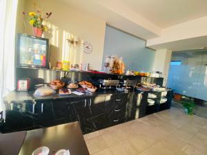 a kitchen with a counter with food on it at Hotel Oxford Inns&Suites in Timişoara