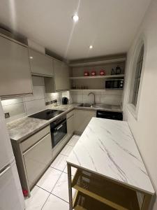 a kitchen with a sink and a table in it at Luxury Stay near London Eye zone 1 in London