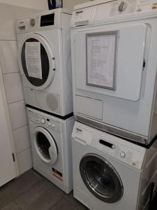 three washing machines and a washer and dryer in a room at Hotel Franken an der Messe in Frankfurt/Main