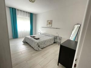 a bedroom with a bed and a dresser and a mirror at Yaya's House - Venice in Mestre