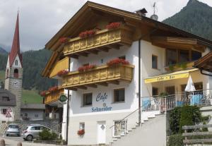 a building with two balconies and a clock tower at Cafe Schneider in Lappago