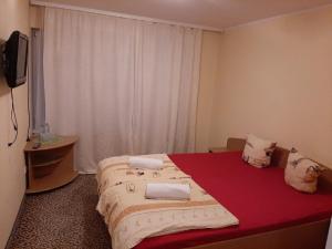 a bedroom with a bed with two pillows on it at Park Hotel Kekava in Ķekava