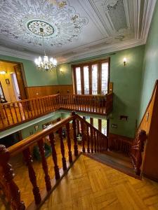 an ornate staircase in a home with a ceiling at Guest House Top Floor in Tʼelavi