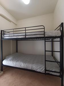 a bedroom with two bunk beds in a room at maison de campagne in La Celle-Saint-Cyr