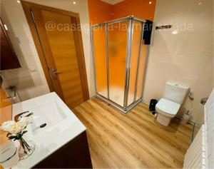 a bathroom with a shower and a white toilet at CASA GLORIA - LA MAR SALADA in Combarro +26 photos
