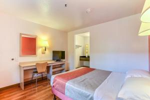 a hotel room with a bed and a desk at Motel 6-Pinole, CA in Pinole