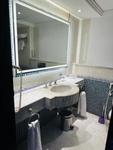 a bathroom with a sink and a large mirror at Private Luxury Villas at Sharm Dreams Resort in Sharm El Sheikh