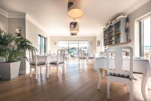 a dining room with a white table and chairs at Driftwood B&B in Brixham +38 photos