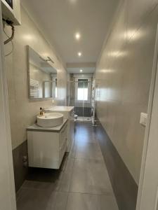 a white bathroom with a sink and a mirror at Yaya's House - Venice in Mestre