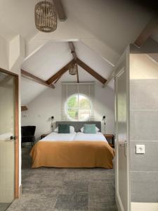 a bedroom with a bed and a large window at Duinstrand Burgh-Haamstede in Burgh Haamstede