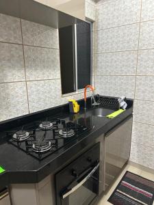 a kitchen with a stove and a sink at Apartamento centro de Paulista-Pe in Paulista