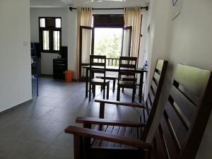 a dining room with a table and chairs at VILLA MAANE by GOODWILL in Hikkaduwa