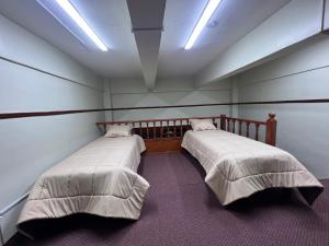 リマにあるCONACO BUILDINGのベッド2台が備わる部屋