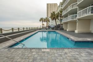 a swimming pool with a view of the ocean at Waters Edge in Myrtle Beach