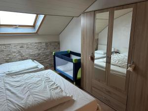 a small bedroom with a bunk bed and a mirror at Chez nathalie in Habay-la-Neuve