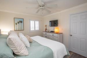 a bedroom with a bed with a ceiling fan at Waters Edge in Myrtle Beach +31 photos