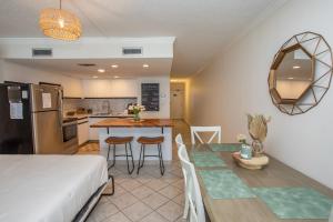 a kitchen and living room with a bed and a table at Waters Edge in Myrtle Beach