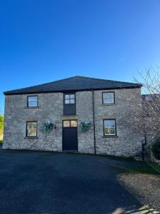 a large stone house with a driveway at The Barn, Romantic country getaway in Dyserth