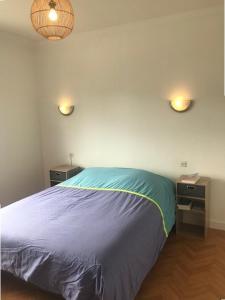 a bedroom with a bed and two night stands at 760 - Charmante maison aux Hôpitaux a mi-chemin entre Erquy et la station des Sables d'Or in Erquy